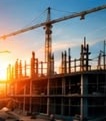 Construction site with cranes at sunset